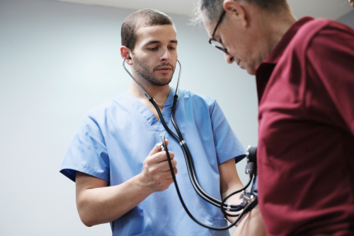 an elderly patient with high blood pressure goes to hospital for medical examination