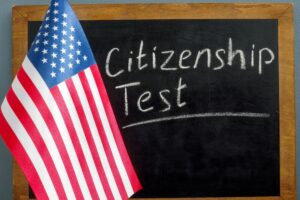 USA flag and inscription citizenship test on the blackboard