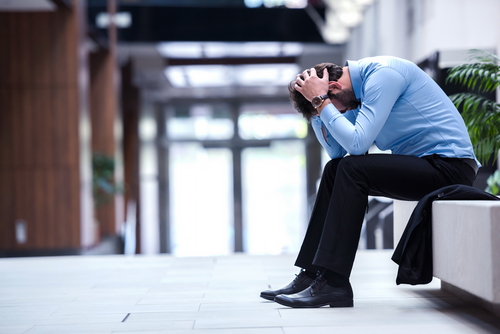 frustrated young business man working on laptop computer at office