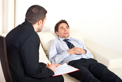 psychiatrist man talking with hypnotized male patient