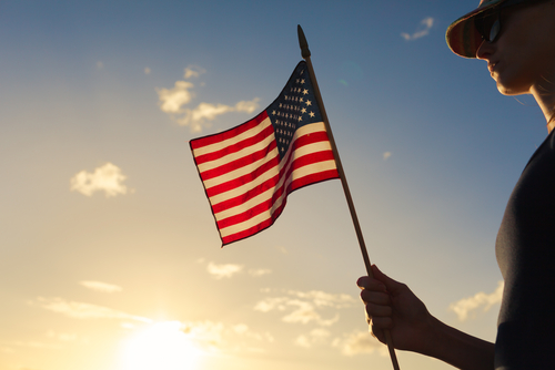 Girl holding USA flag.