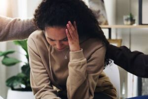 Support group, people and sad woman in therapy for mental health and healing depression.