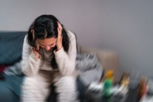 Young woman experiencing severe migraine headache and dizziness